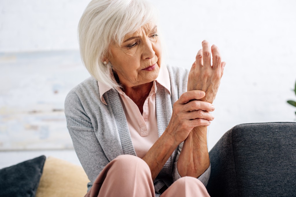 senior woman having hand arthritis and sitting on 2022 12 16 17 21 36 utc 1