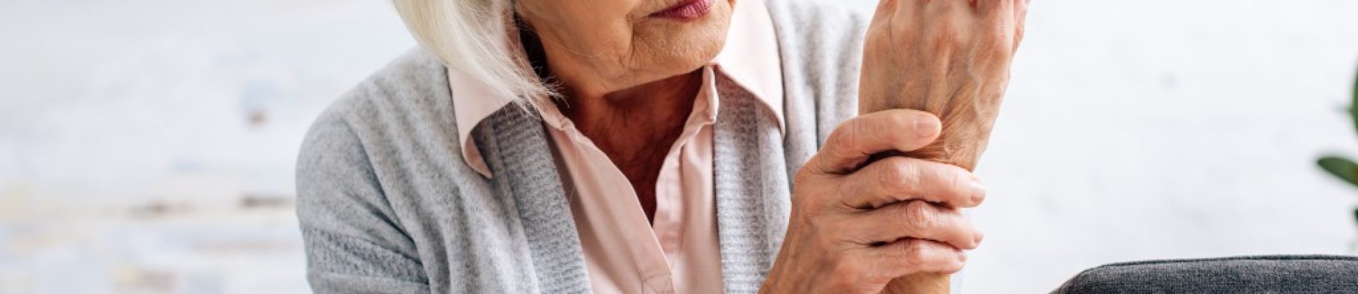 senior-woman-having-hand-arthritis-and-sitting-on-2022-12-16-17-21-36-utc (1)